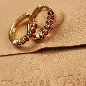 Gold plated huggies with red crystals